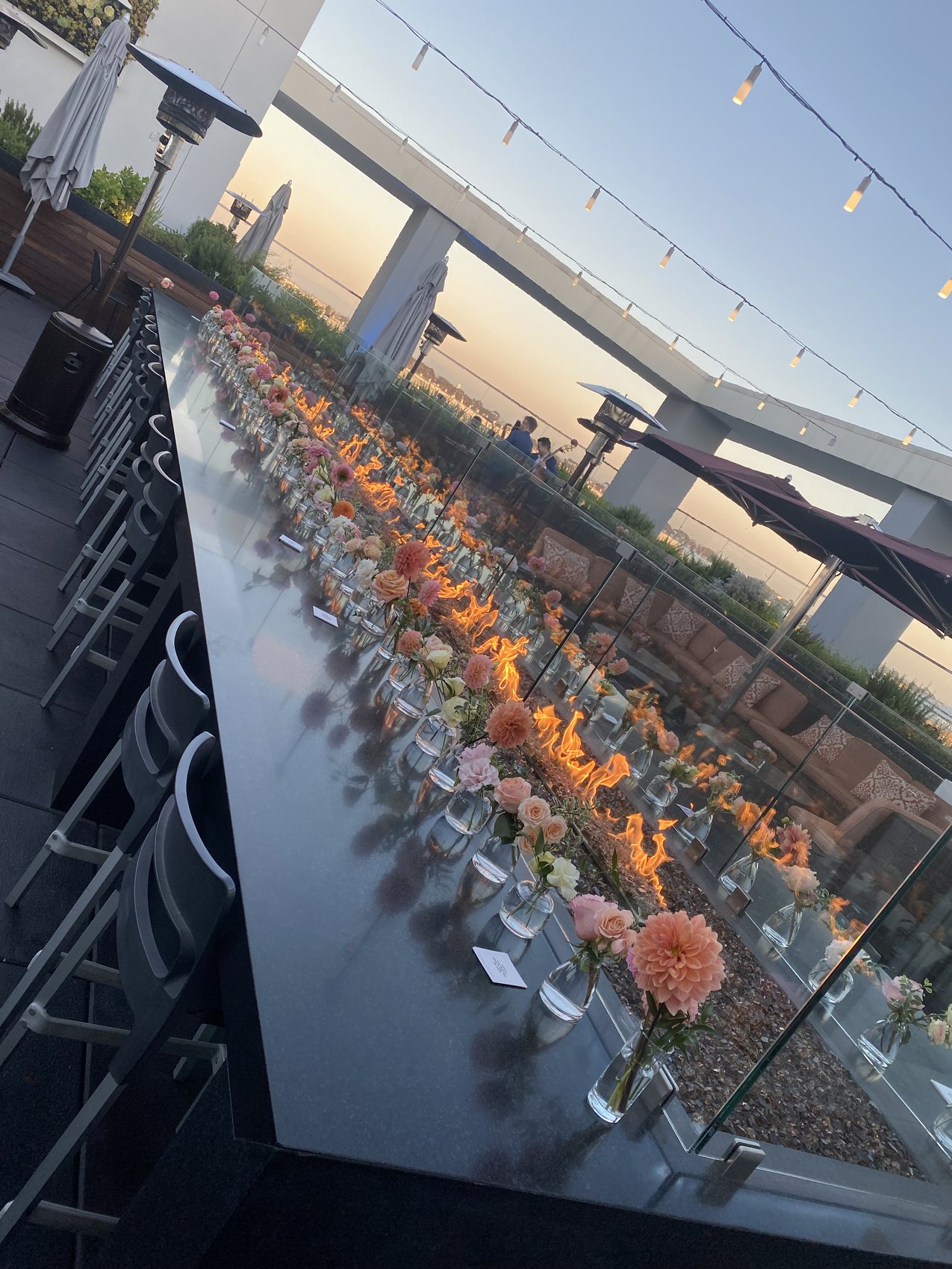 Rooftop dinner table set with florals for a provider event